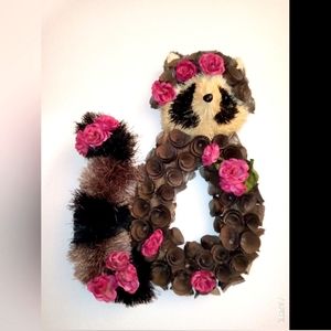 Sisal handmade raccoon with wood shavings and flowers.